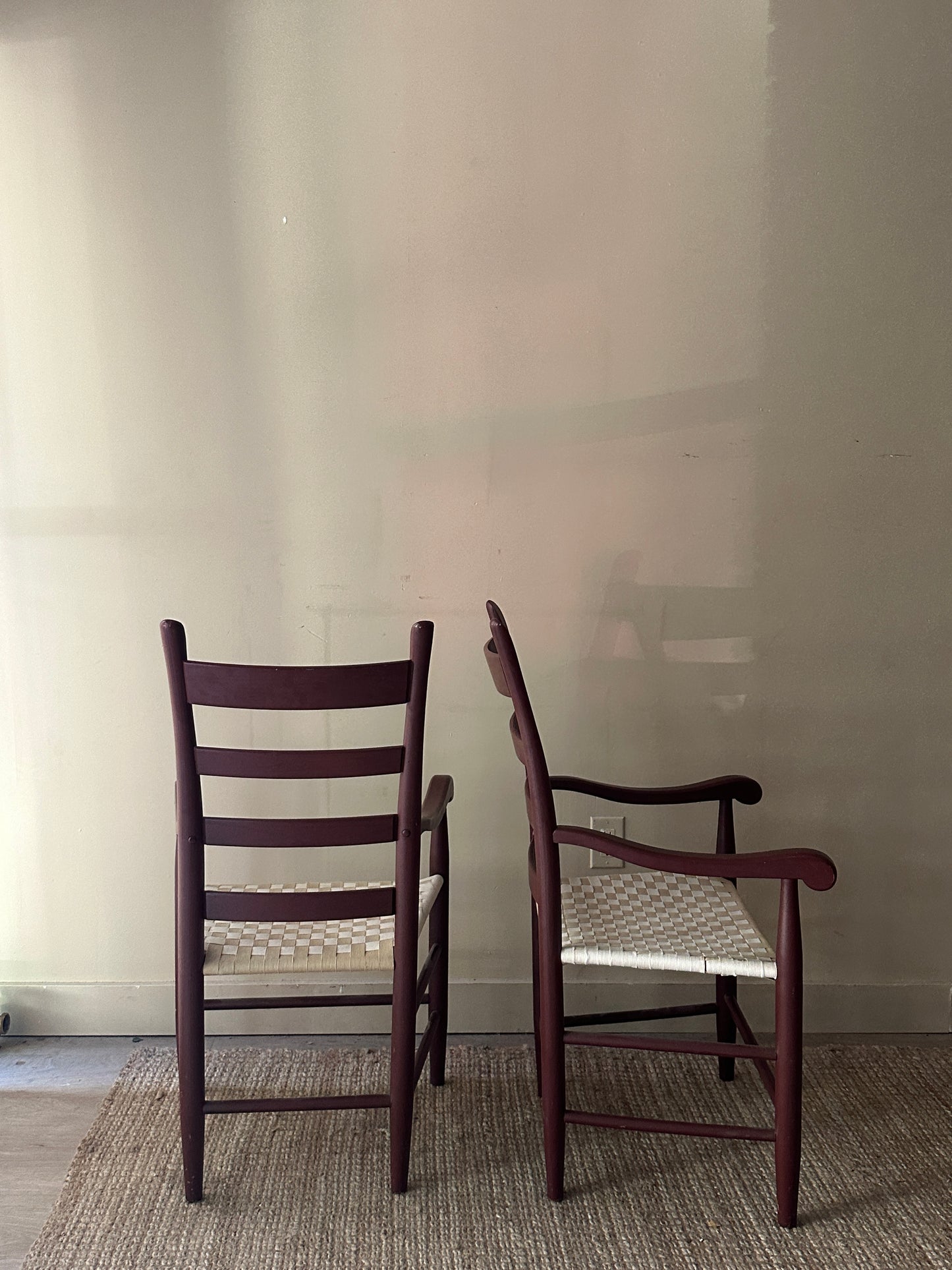 Woven chairs with arms. Sold as a pair.