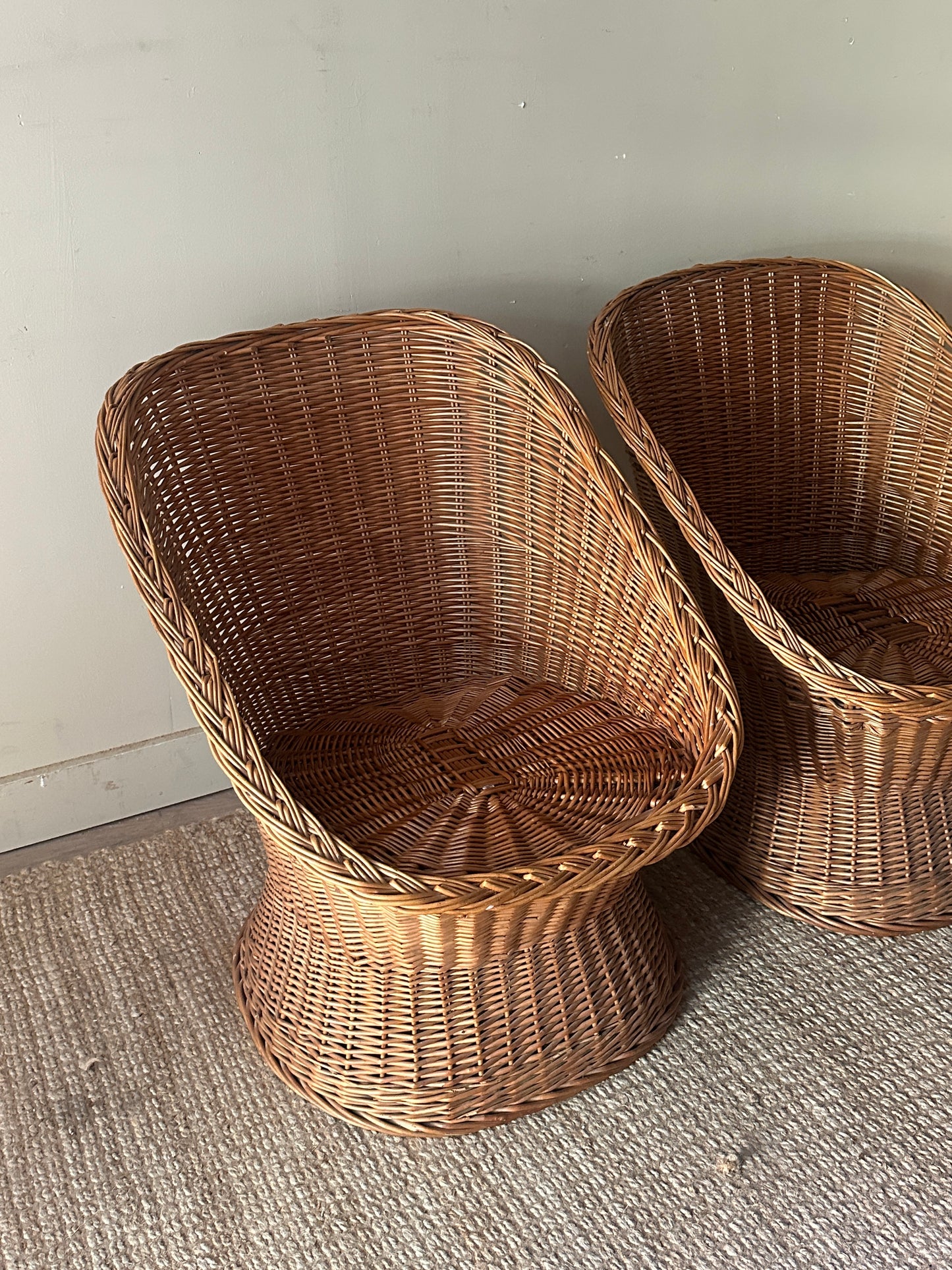 Wicker lounge chairs. Sold individually.