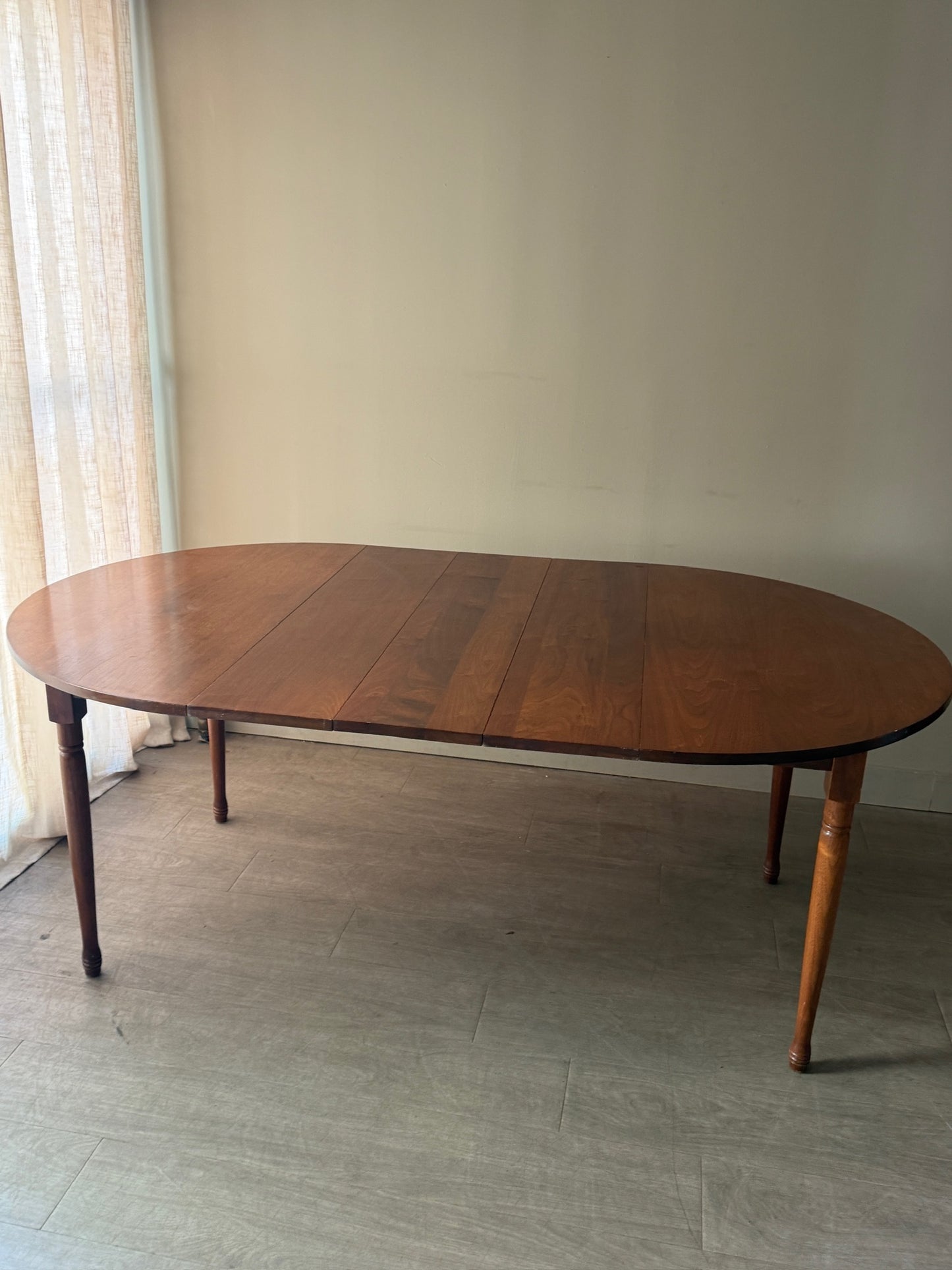 Round walnut dining table with extensions