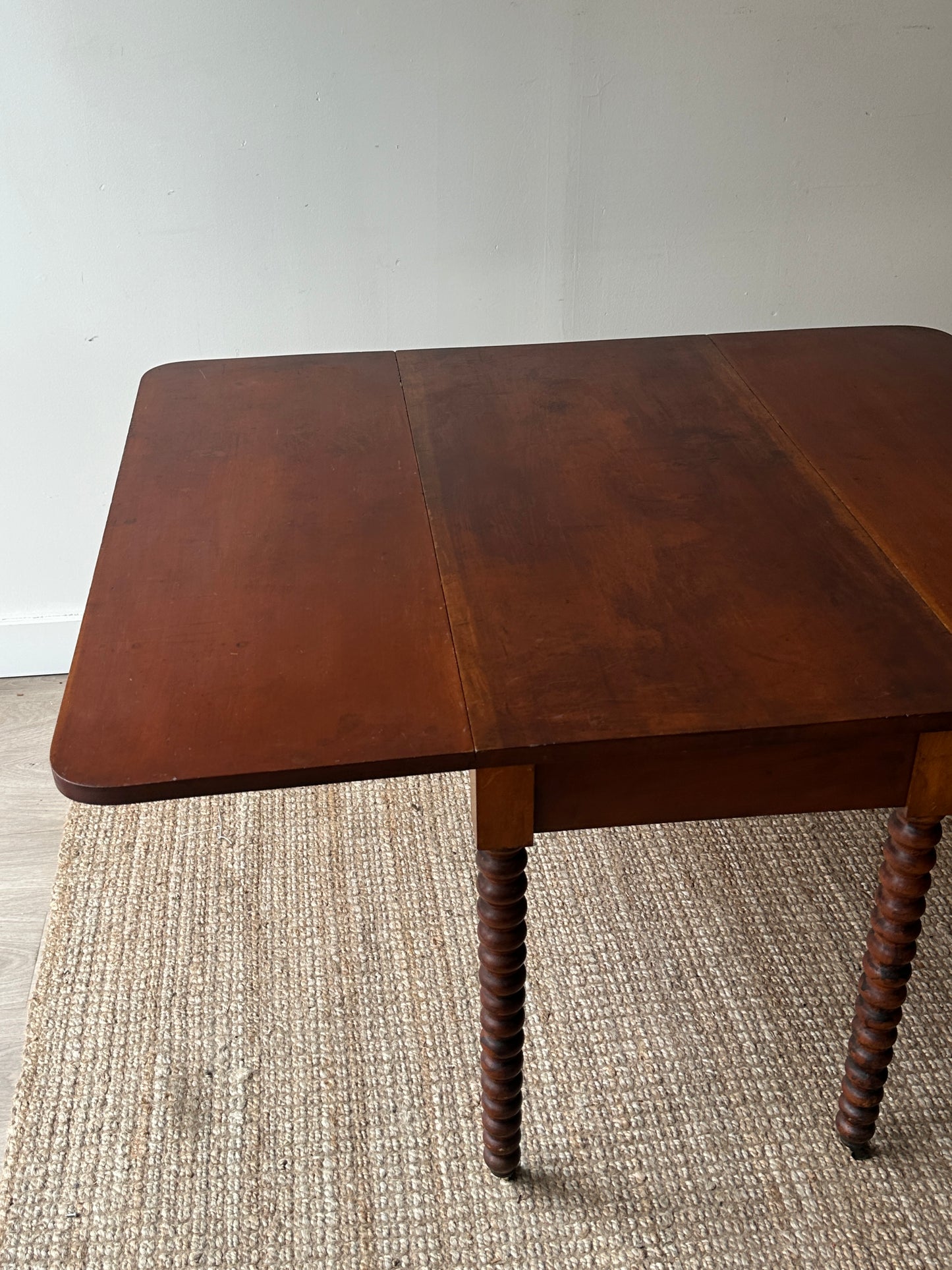 Cherry drop leaf table with bobbin legs.