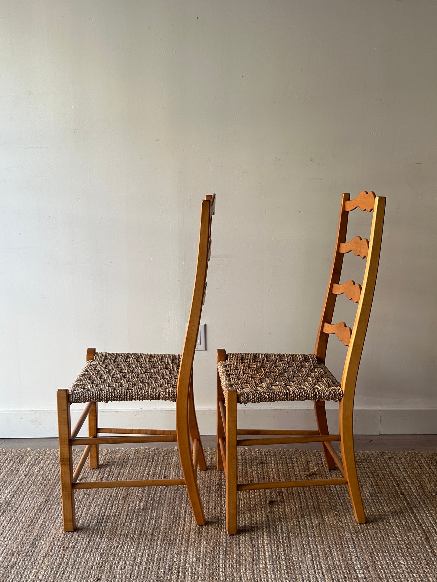 Ladder back chairs with woven seats. Sold as a pair.