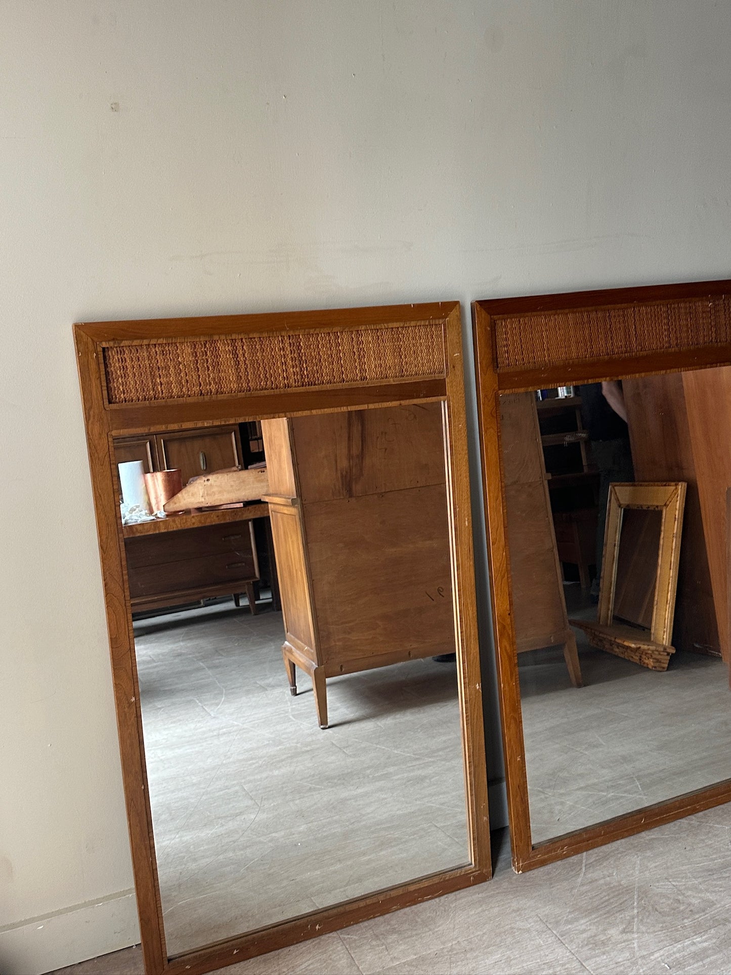 2 walnut and cane mirrors. Sold individually.