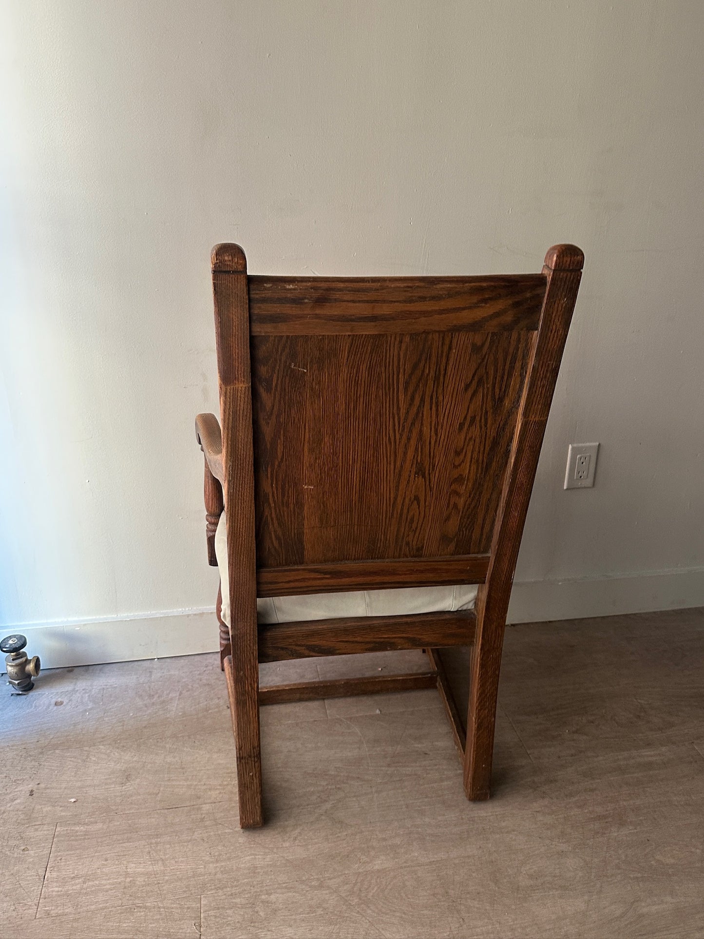 Carved oak and leather armchair
