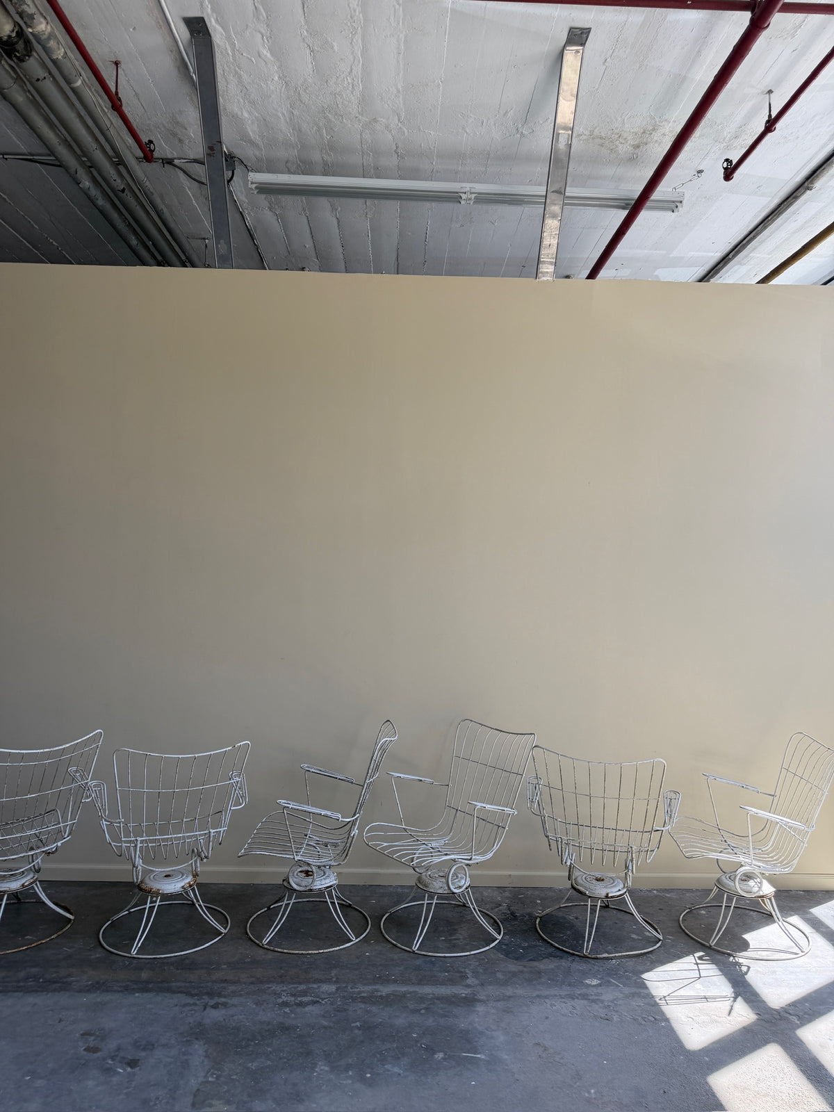 White swivel patio chairs. Sold individually.