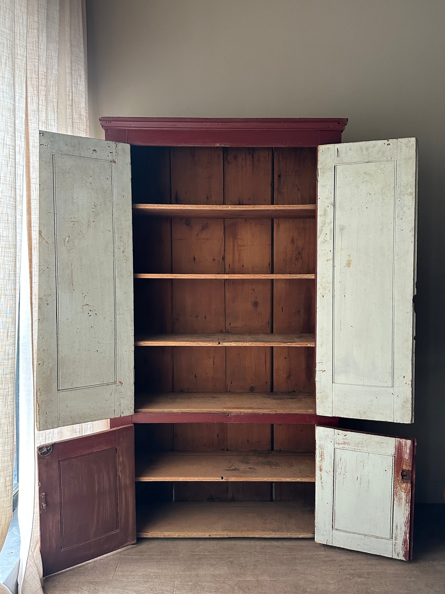 Red painted farmhouse cupboard