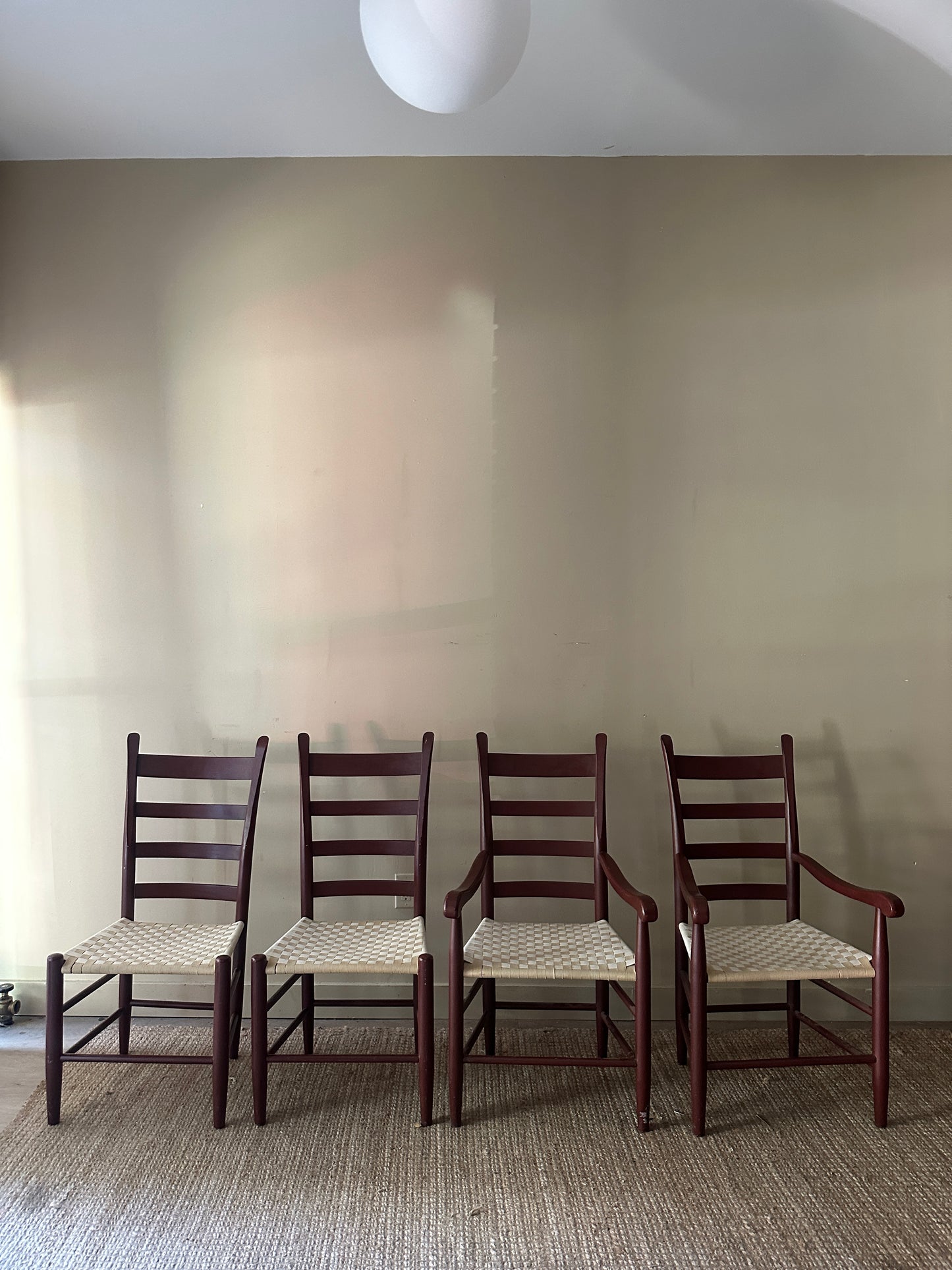 Armless woven chairs. Sold as a pair.