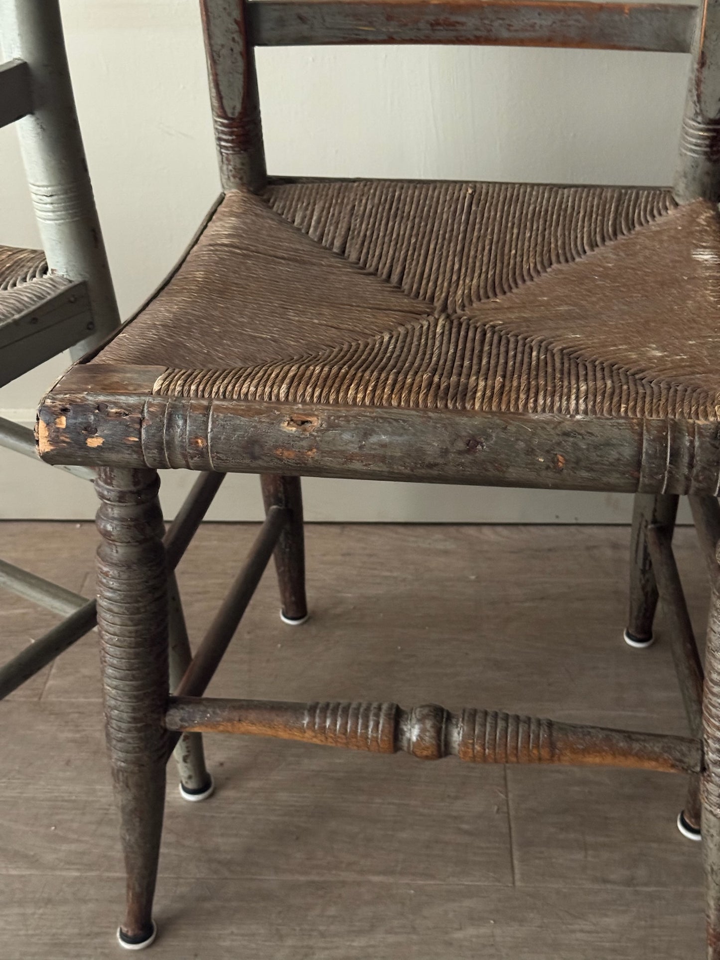 Carved dining chairs with rush seats. Sold in pairs.