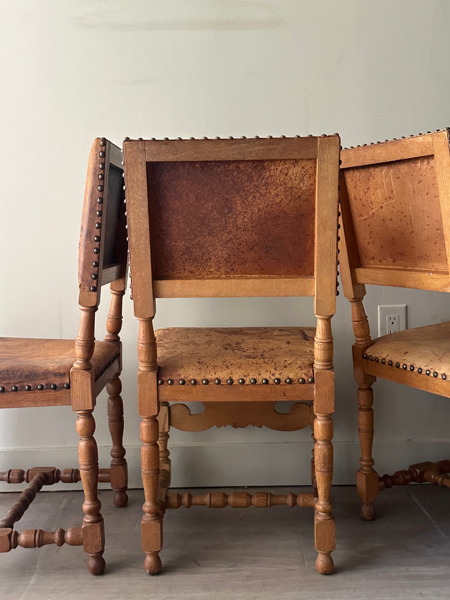 Leather and oak dining chairs. Sold individually.