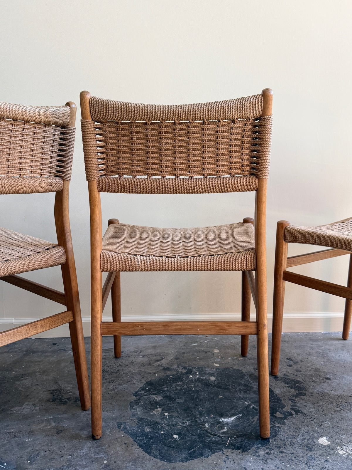 Danish oak and papercord chairs. Sold individually.