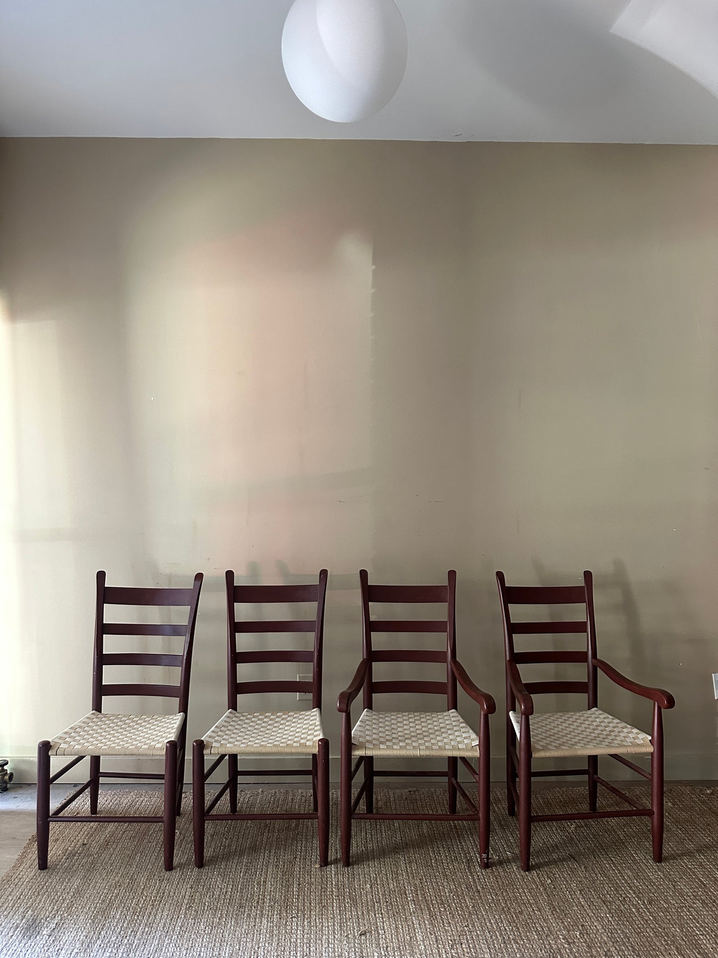 Woven chairs with arms. Sold as a pair.
