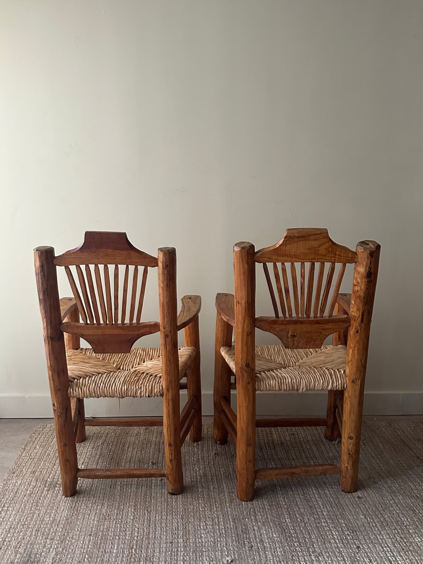 Pine rush seat dining chairs with arms. Sold individually.