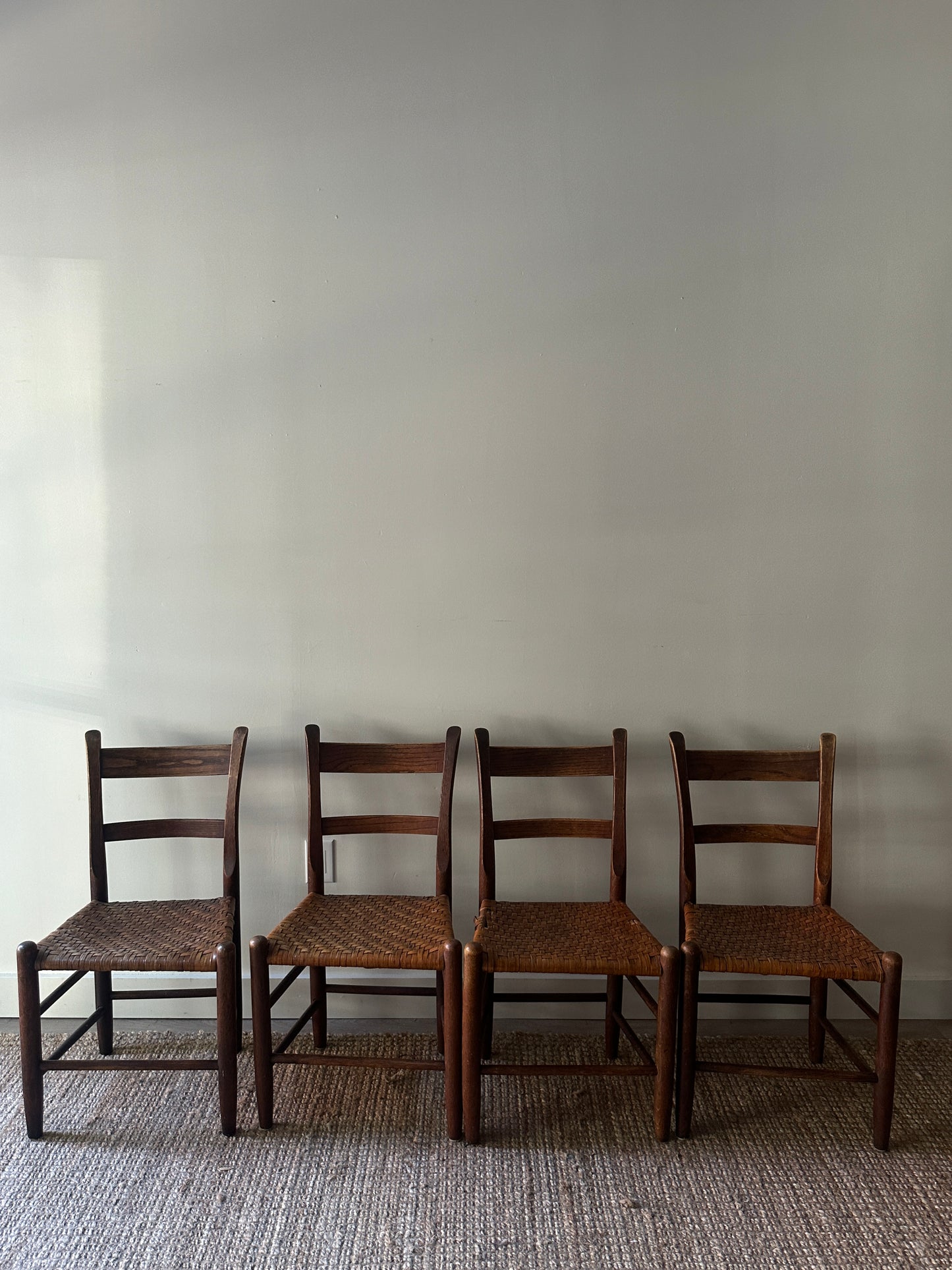 4 woven chairs. Sold individually.
