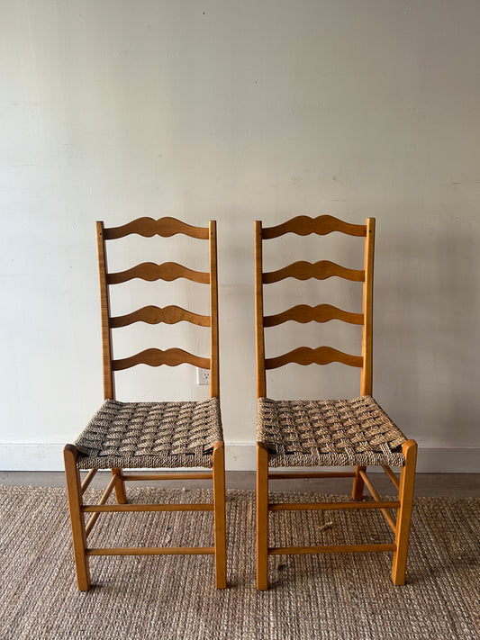 Ladder back chairs with woven seats. Sold as a pair.