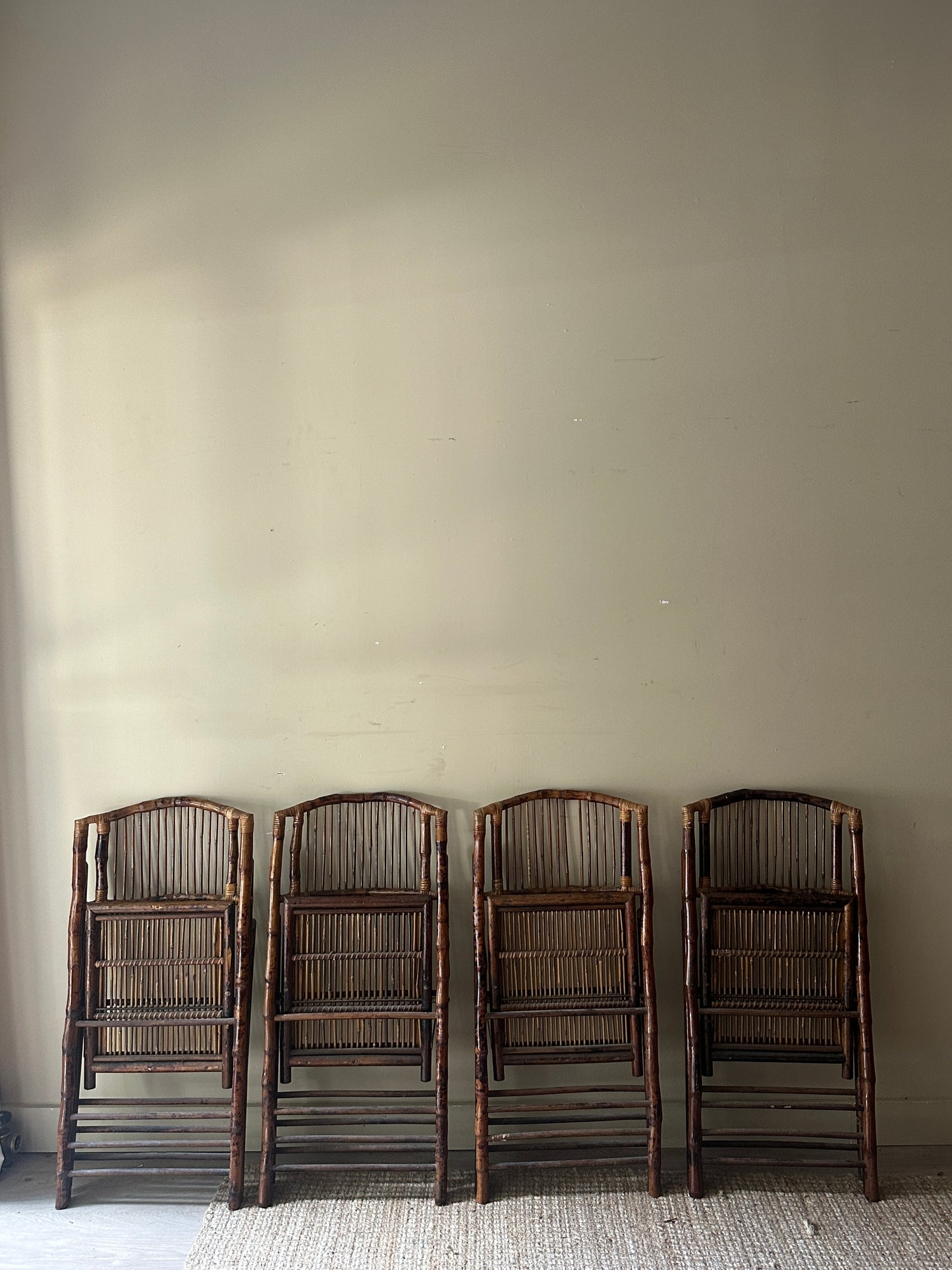 Scorched bamboo folding chairs. Sold in pairs.