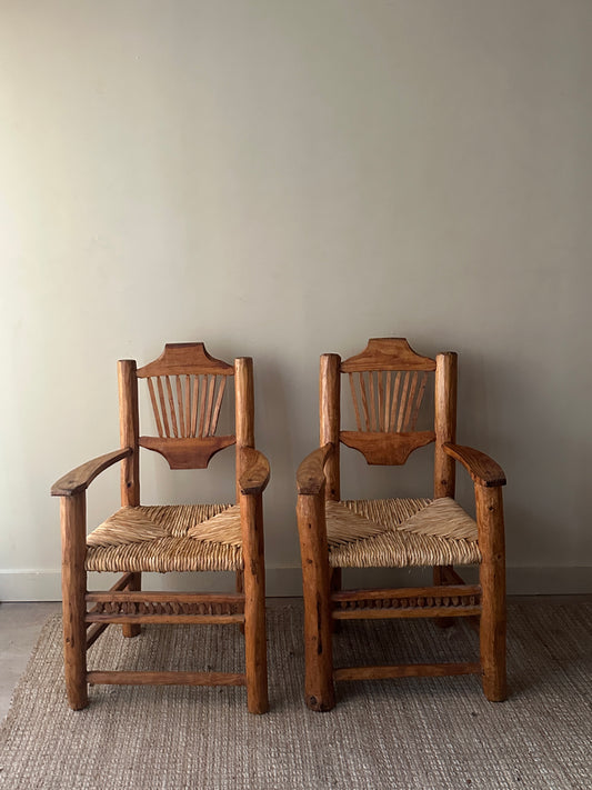 Pine rush seat dining chairs with arms. Sold individually.