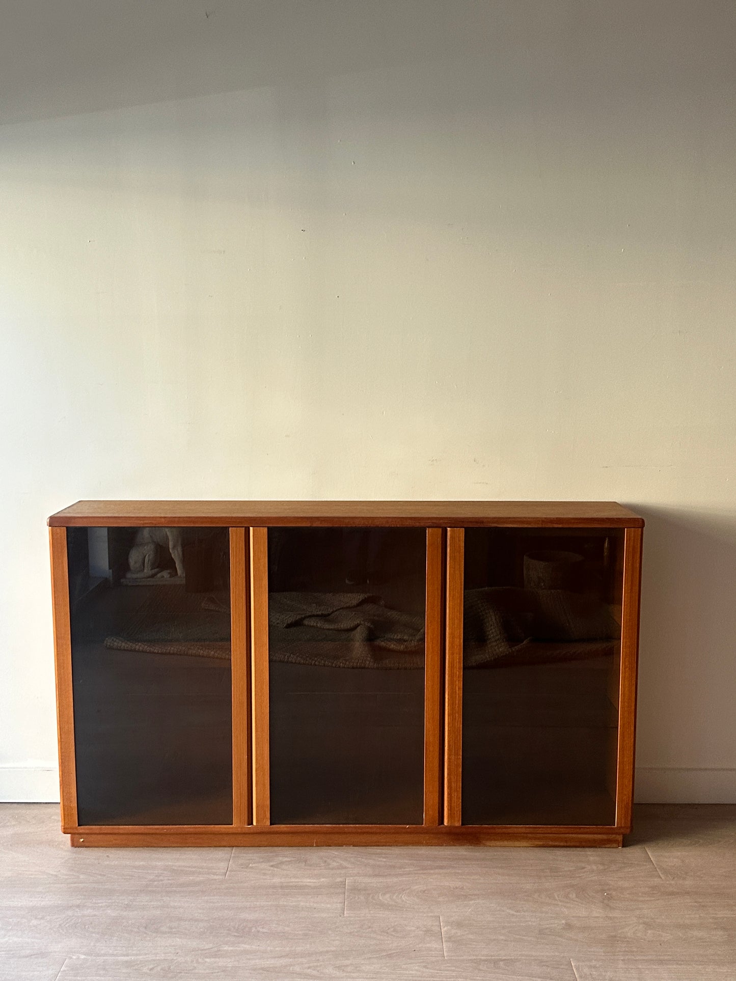 Smoked glass and teak bookcase