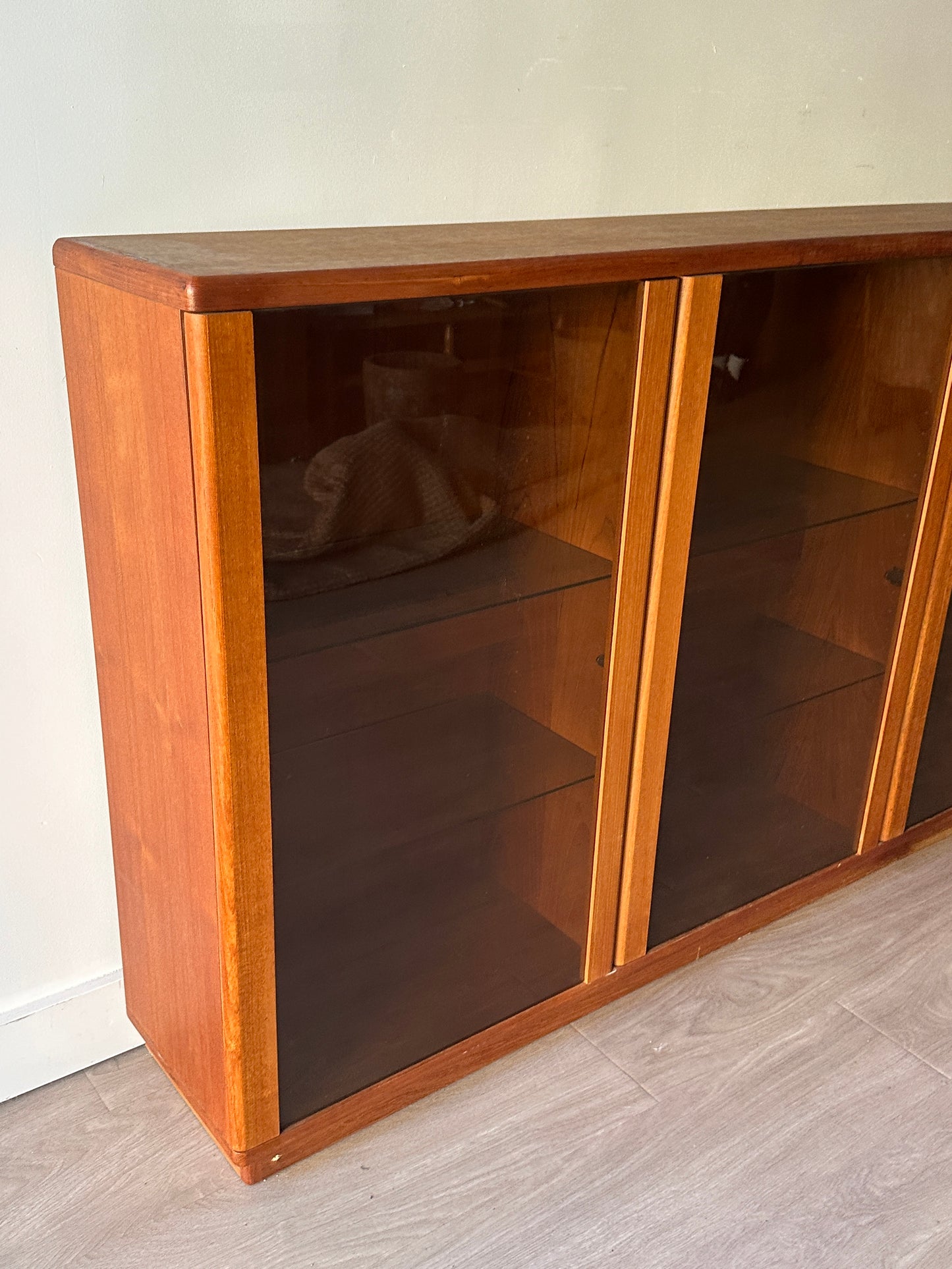Smoked glass and teak bookcase