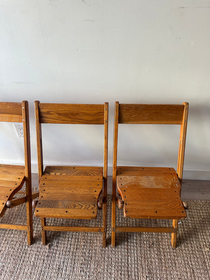 4 oak folding chairs. Sold individually.