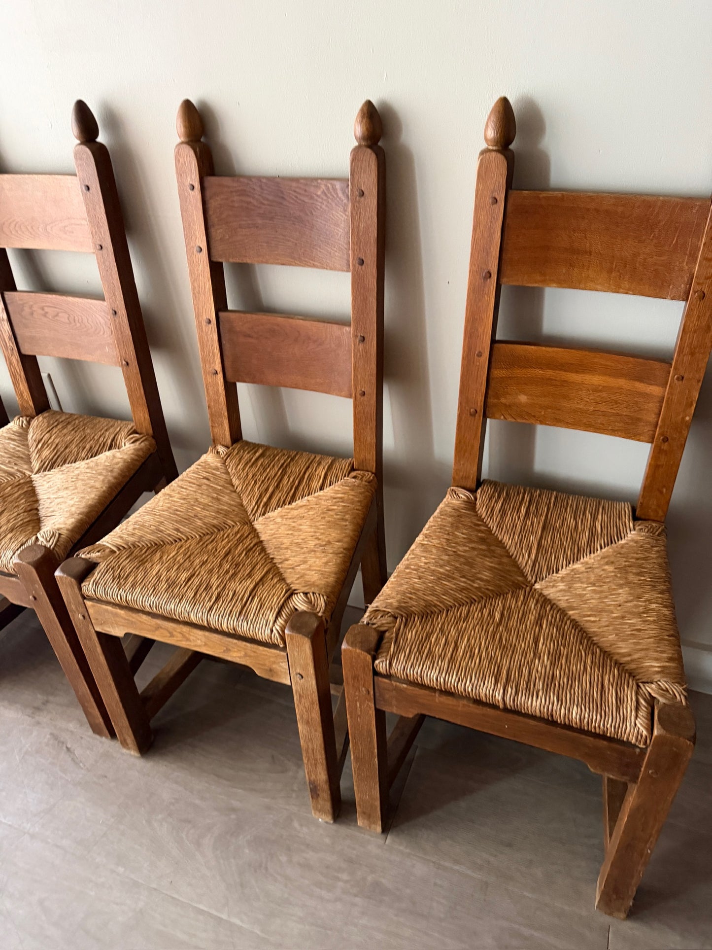 Dutch Brutalist oak rush seat dining chairs. Sold in pairs.