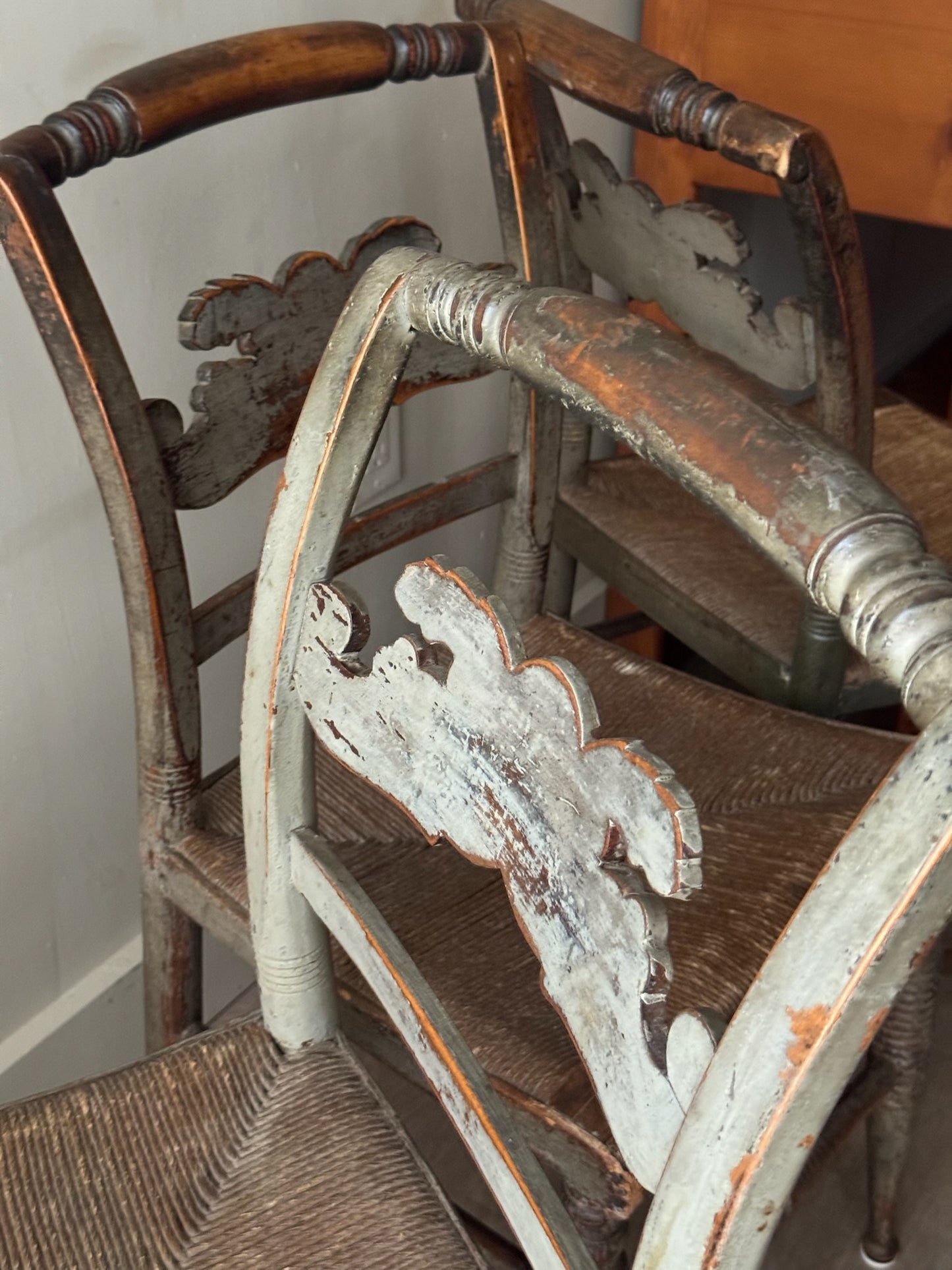 Carved dining chairs with rush seats. Sold in pairs.