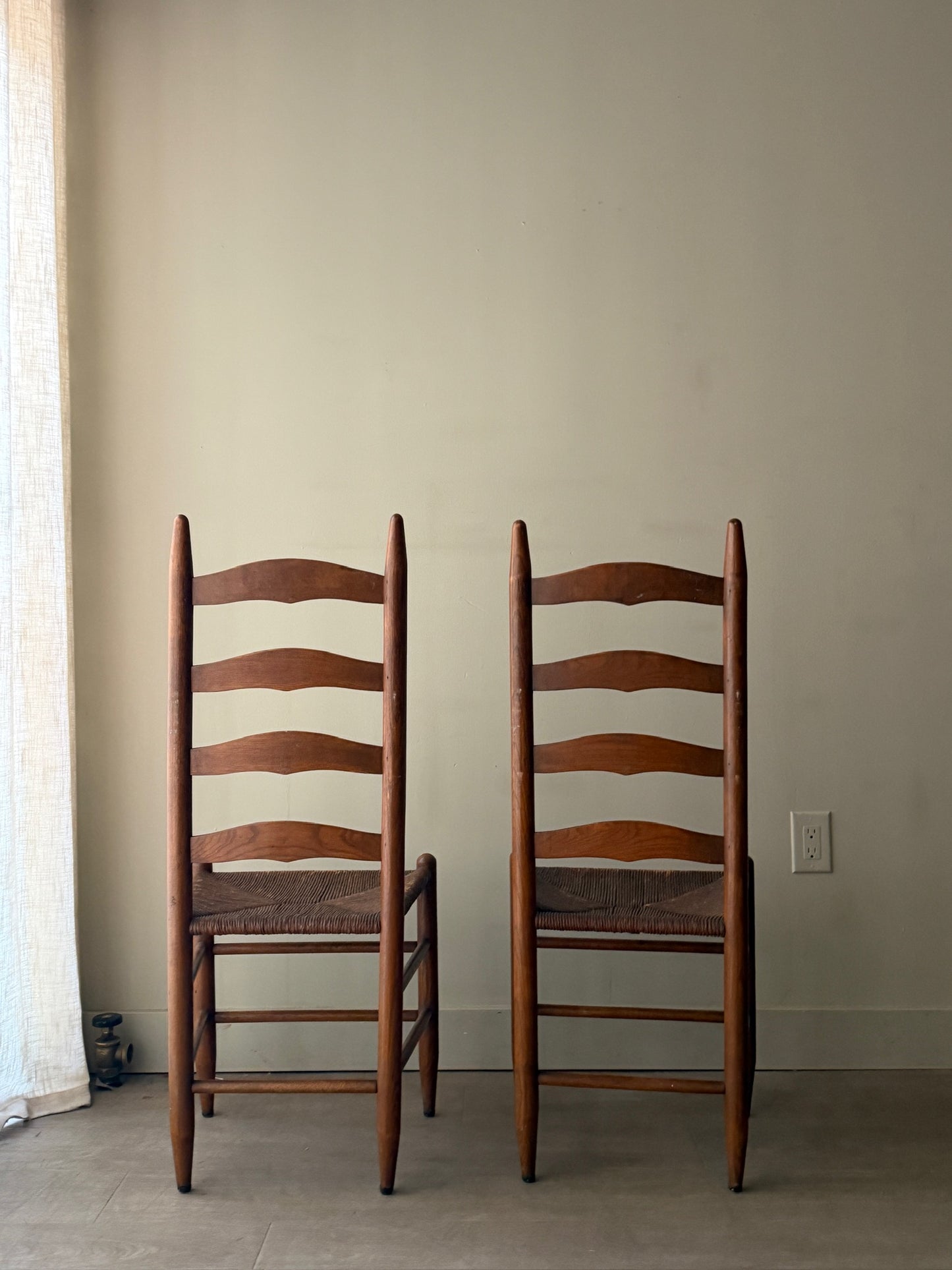 Oak ladder back rush seat dining chairs. Sold as a pair.