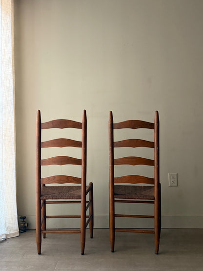 Oak ladder back rush seat dining chairs. Sold as a pair.