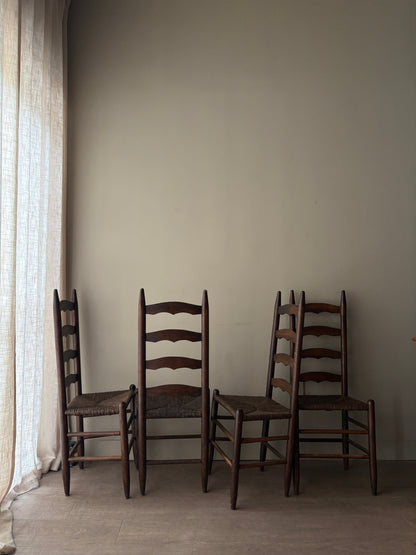 Stained oak rush seat ladder back dining chairs. Sold in pairs.