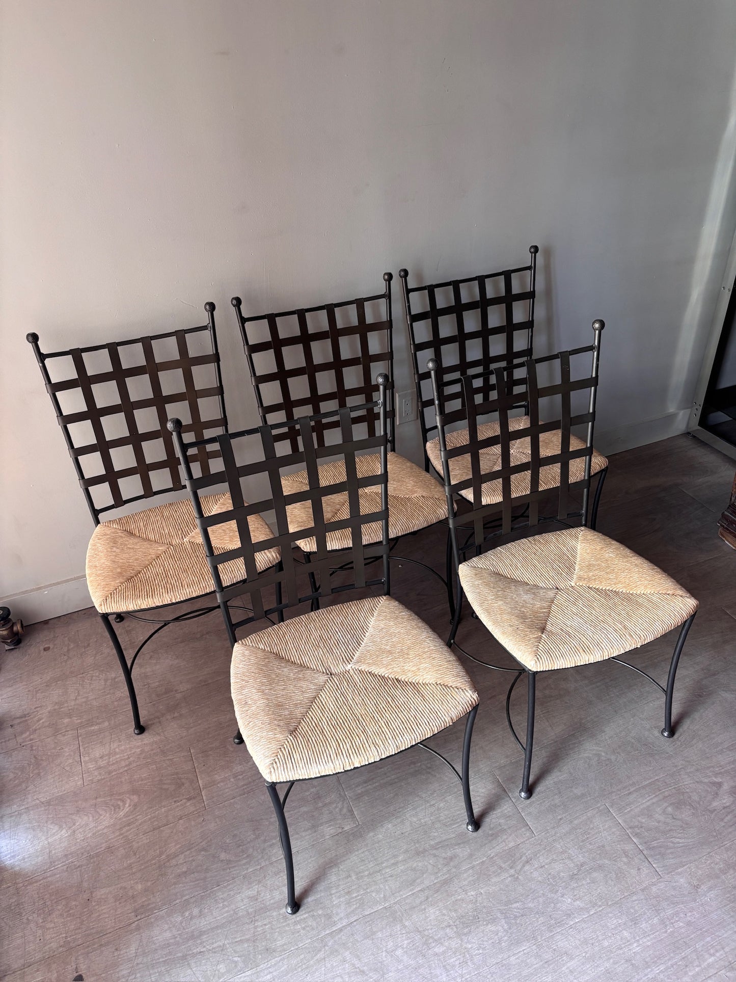 Wrought iron rush seat dining chairs. Sold individually.