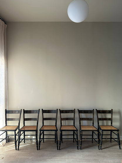 6 cane and black painted dining chairs. Sets of 2.