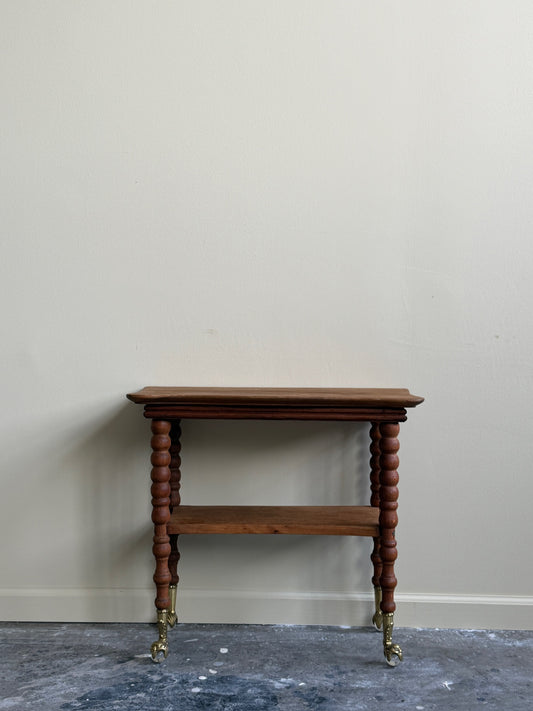 Golden oak side table with brass claw feet