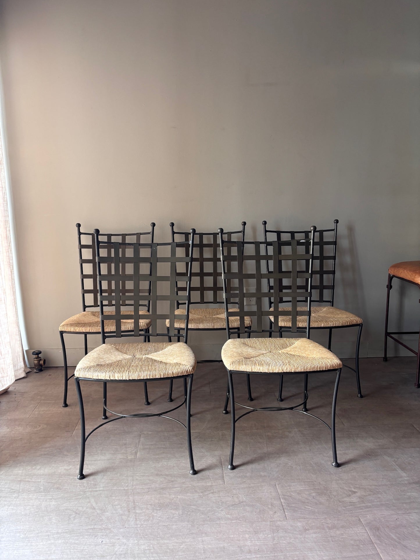 Wrought iron rush seat dining chairs. Sold individually.