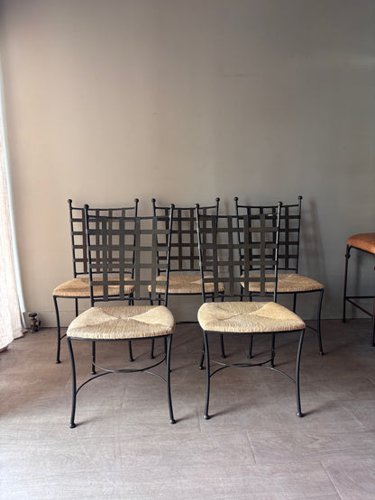 Wrought iron rush seat dining chairs. Sold individually.