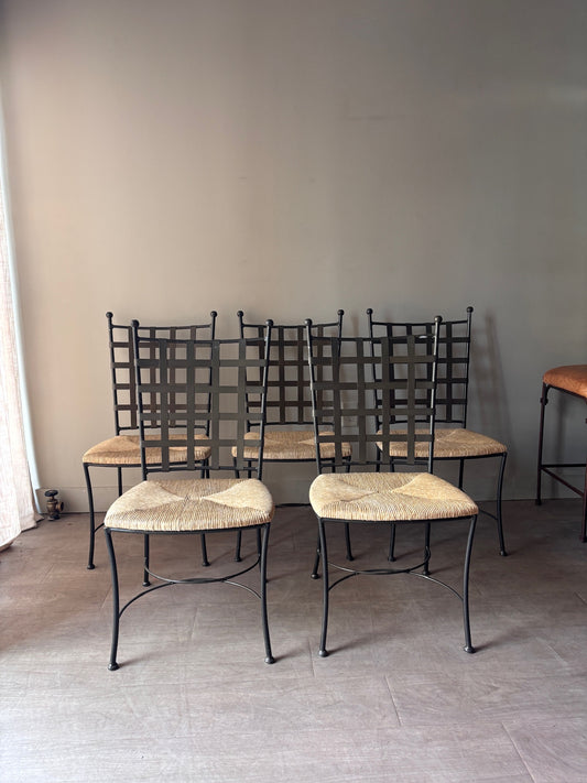 Wrought iron rush seat dining chairs. Sold individually.