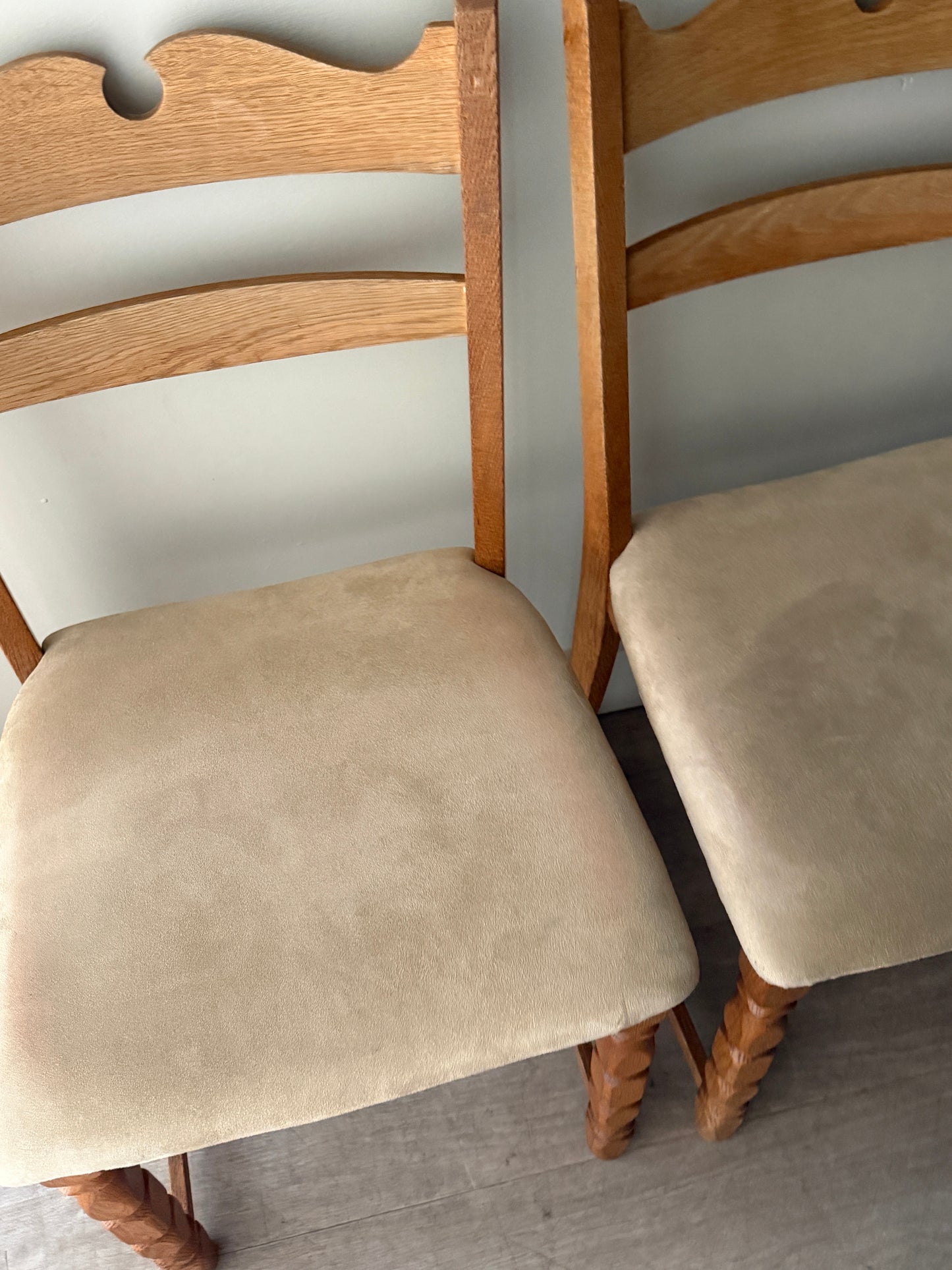 Danish oak dining chairs with suede upholstery. Sold in pairs.