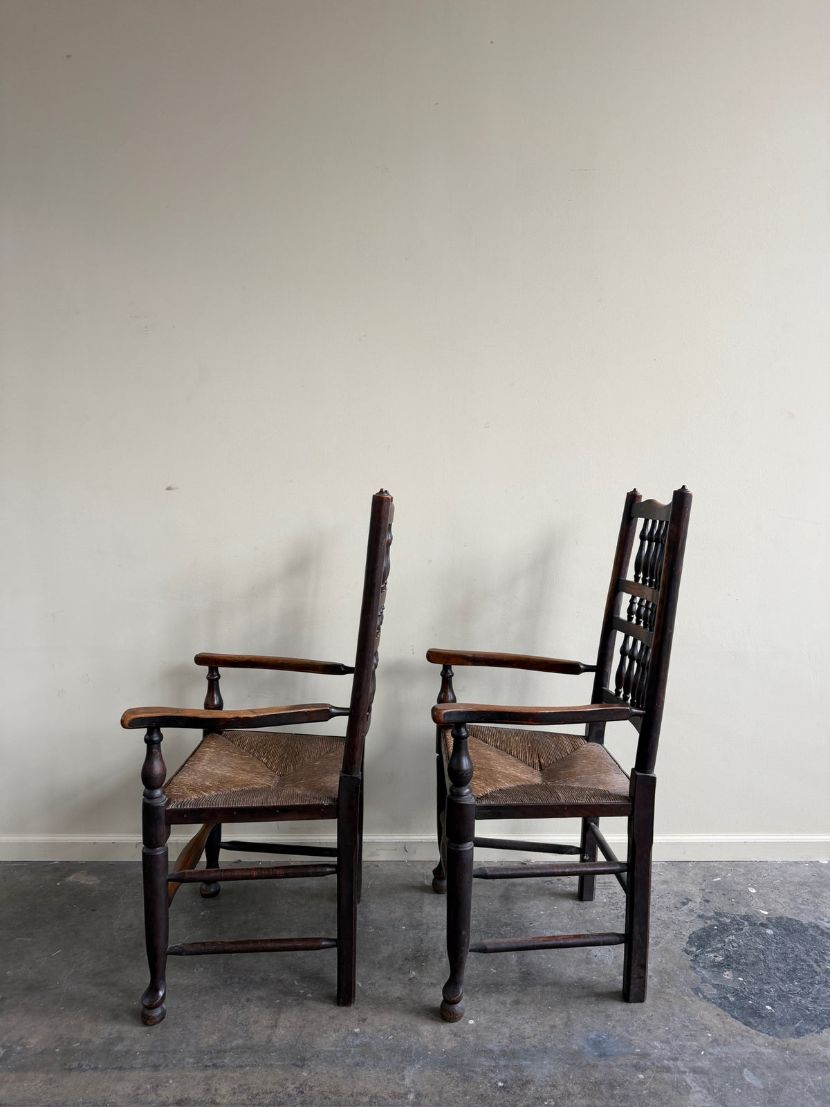 Dutch oak spindle back rush seat armchairs. Sold individually.