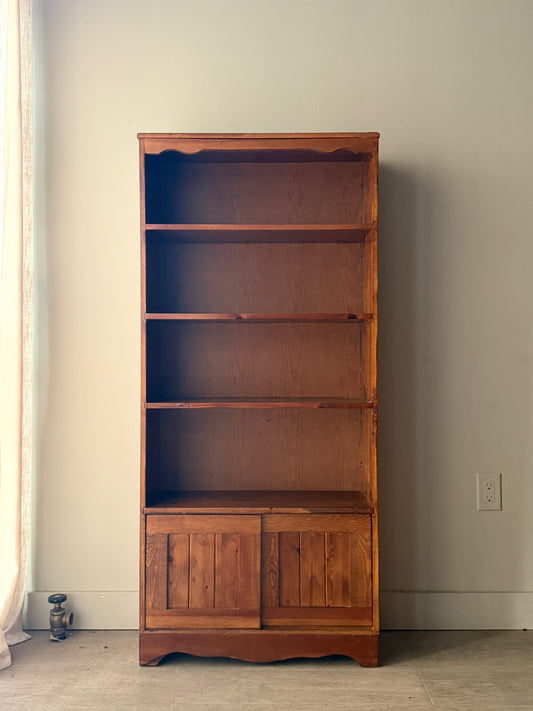 Pine bookcase with sliding doors