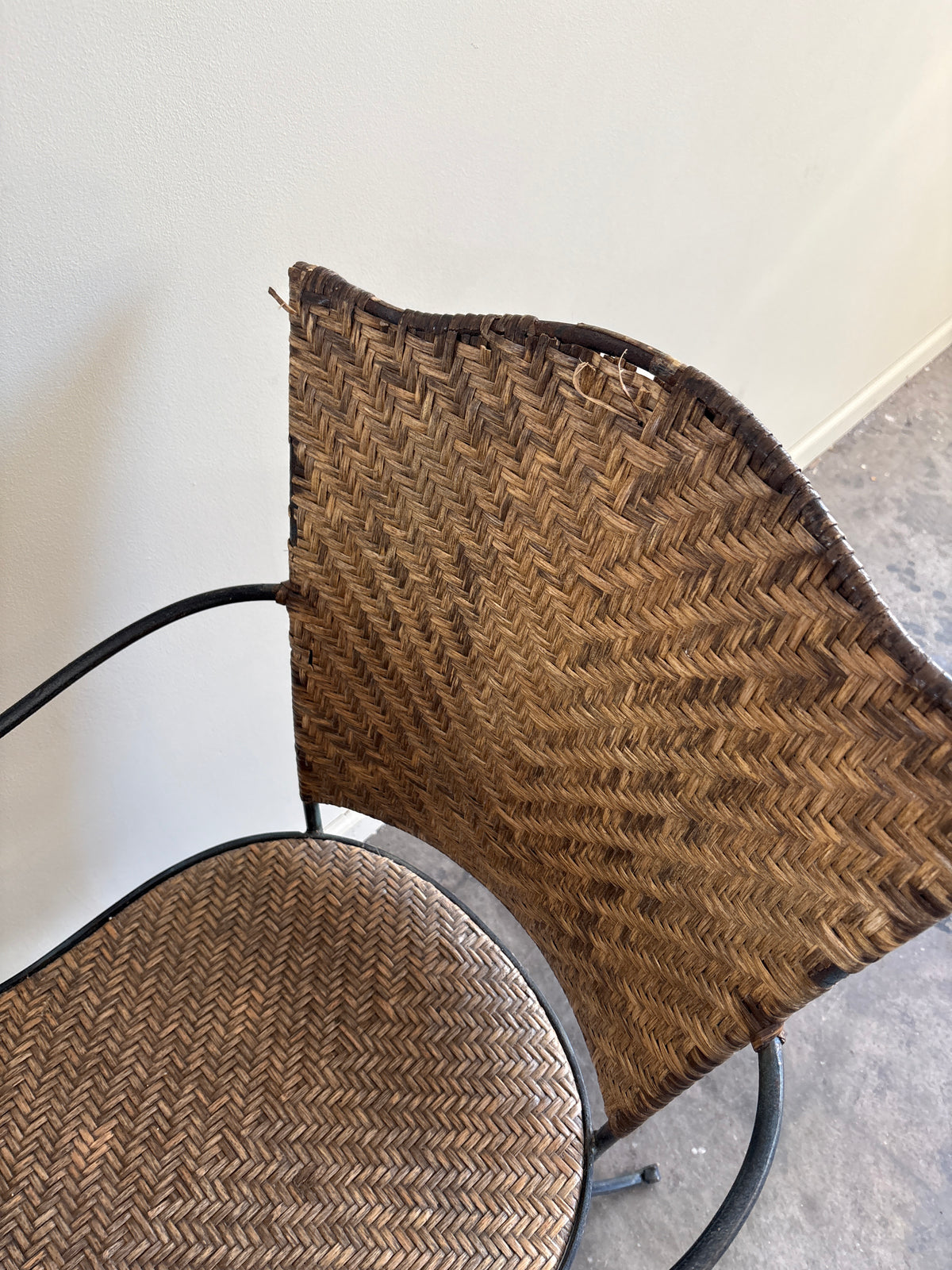 Wrought iron armchairs with woven bamboo backs & seats. Sold individually.