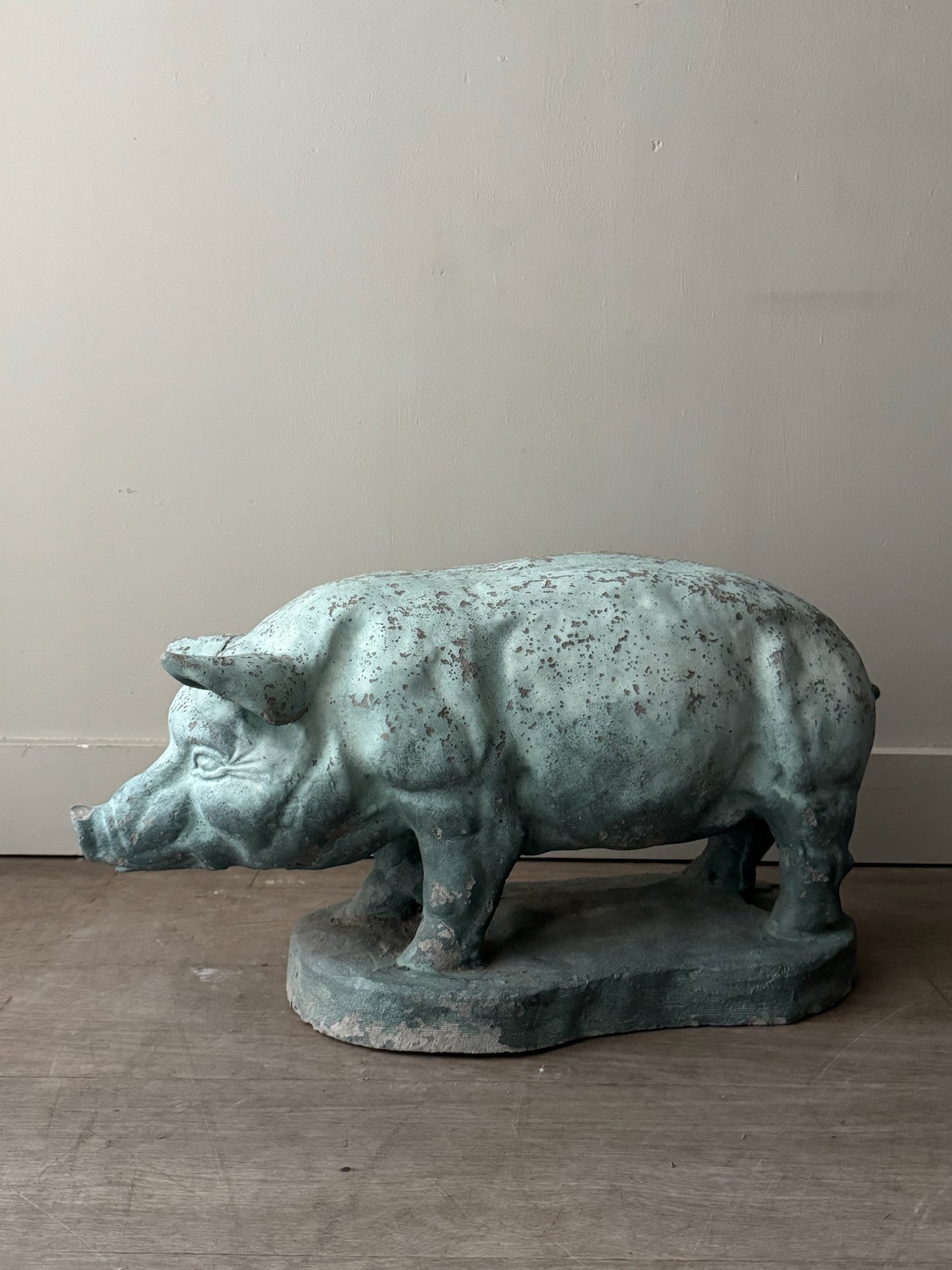 Light blue painted concrete pig