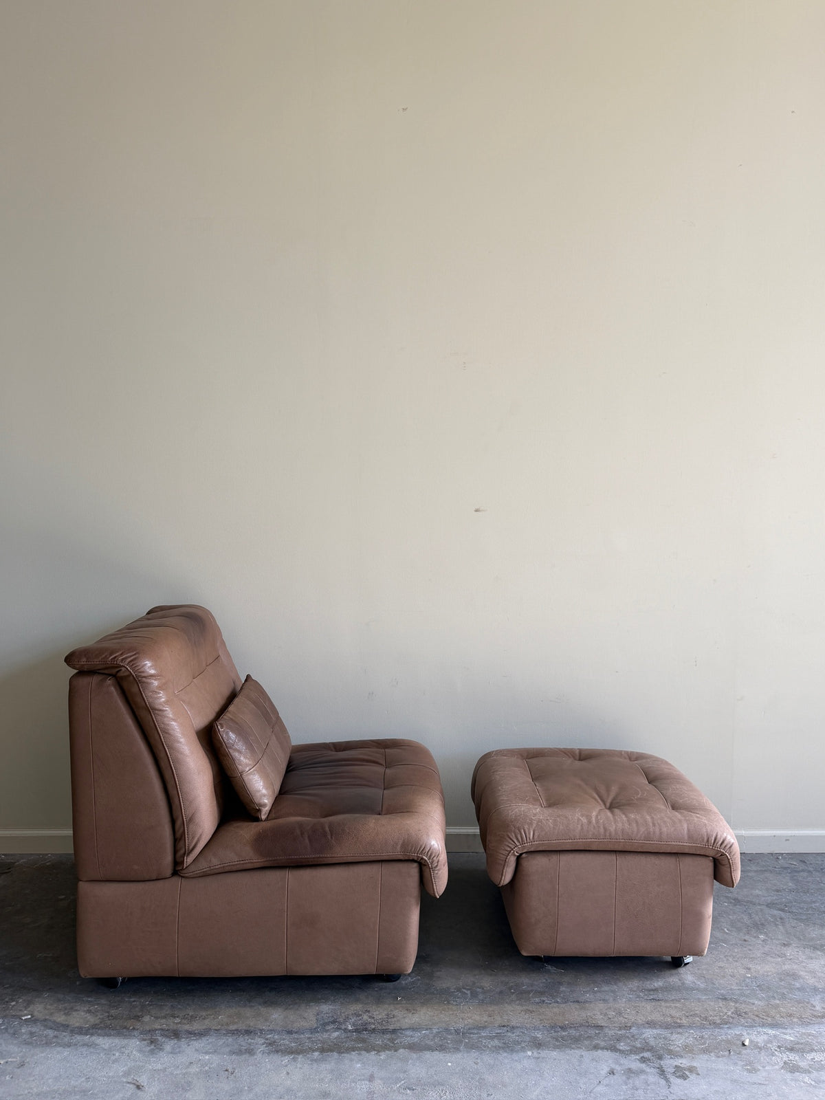 Swiss brown leather lounge chair with ottoman