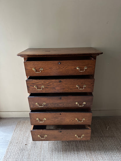 Oak tallboy with brass handles