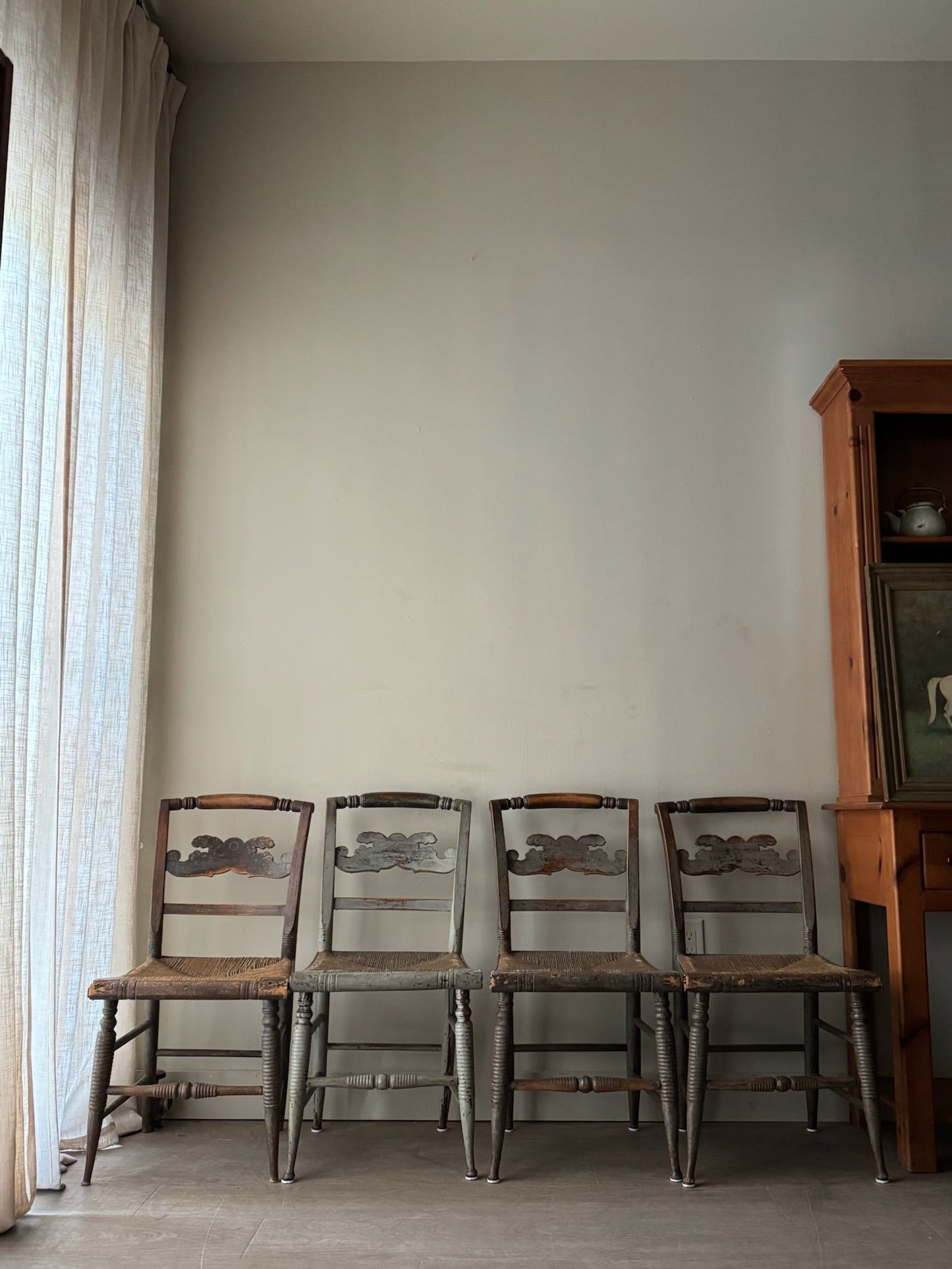 Carved dining chairs with rush seats. Sold in pairs.