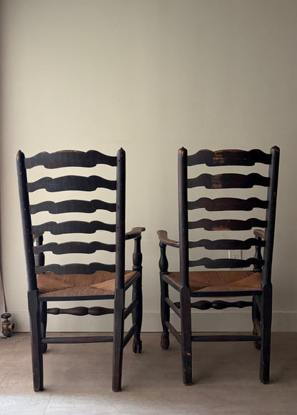 English provincial elmwood ladder back rush seat armchairs. Sold individually.