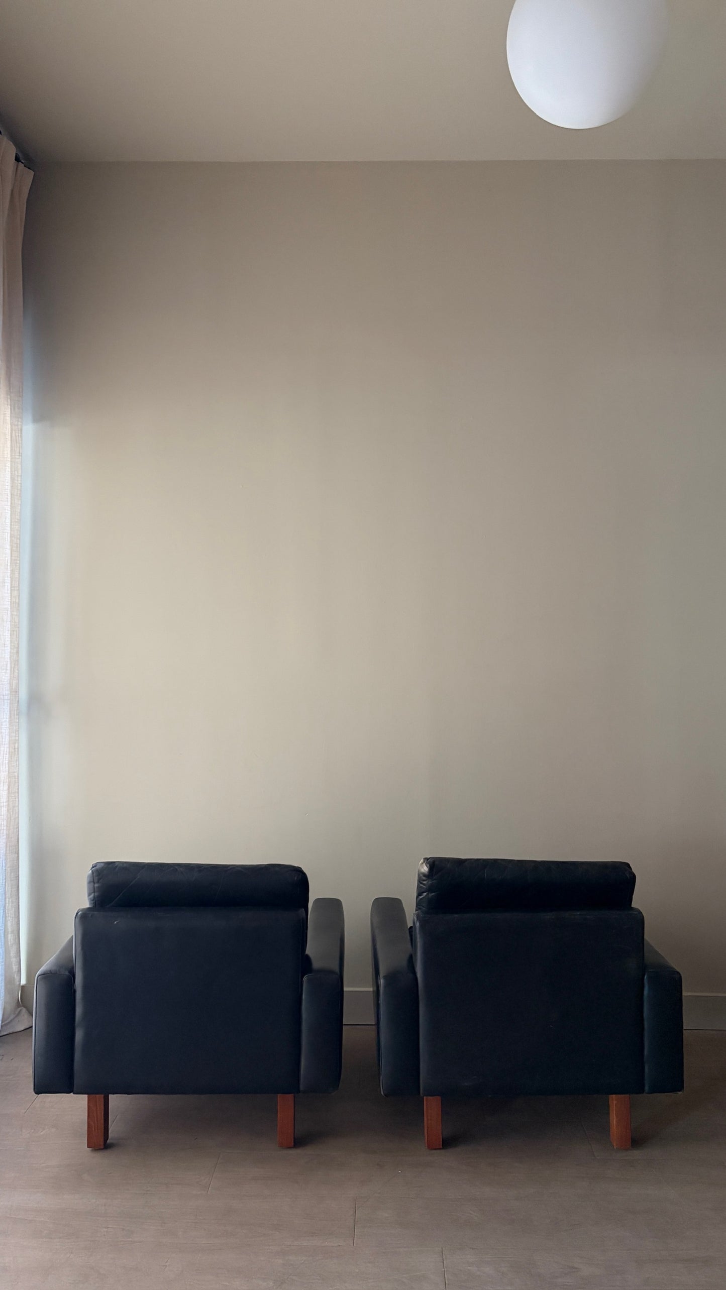 Danish black leather lounge chairs. Sold individually.