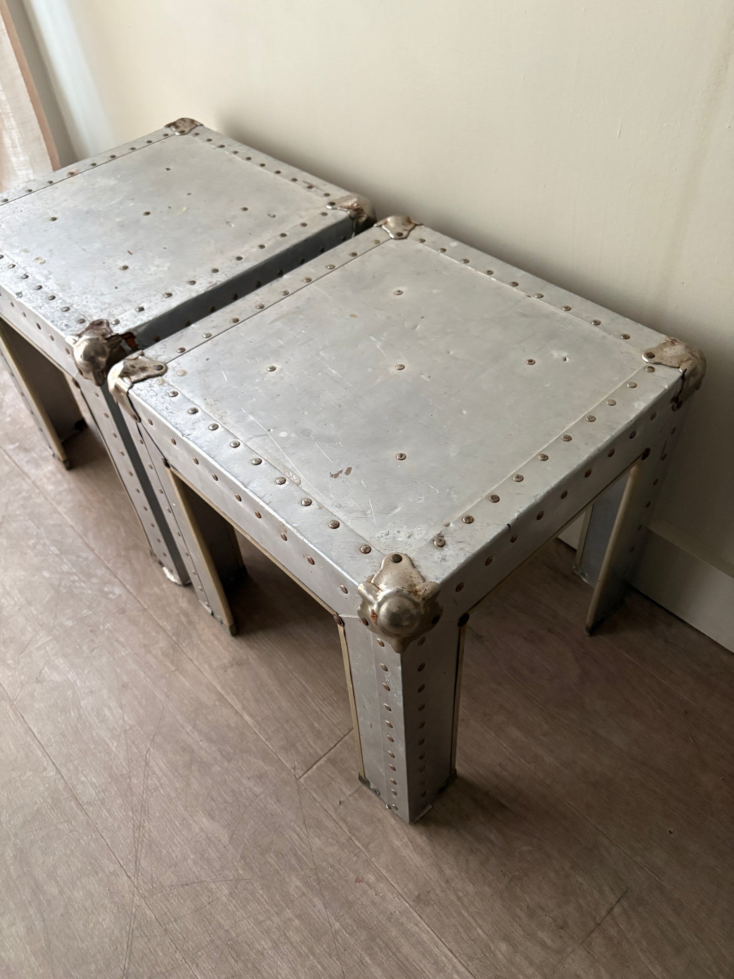 Riveted metal cocktail tables. Sold individually.