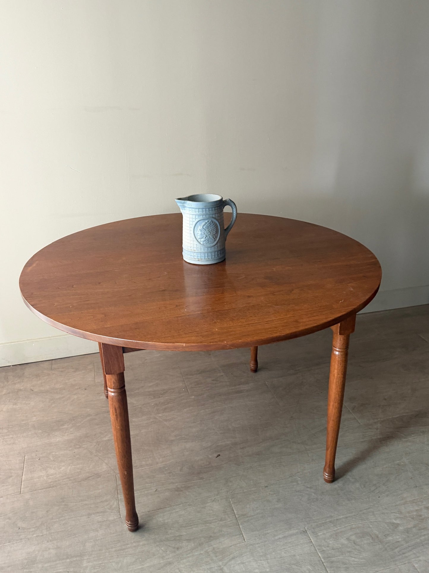 Round walnut dining table with extensions