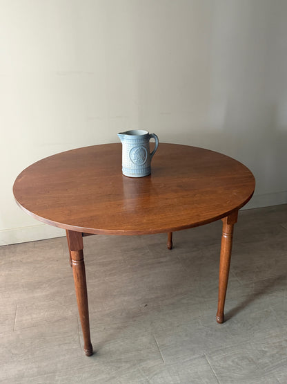 Round walnut dining table with extensions