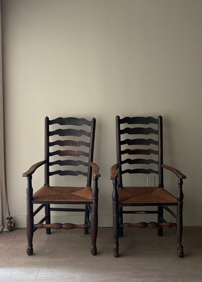English provincial elmwood ladder back rush seat armchairs. Sold individually.