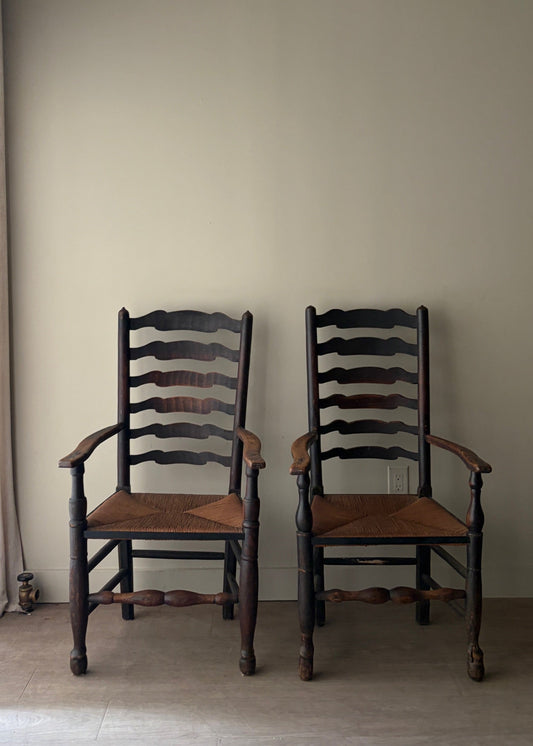 English provincial elmwood ladder back rush seat armchairs. Sold individually.