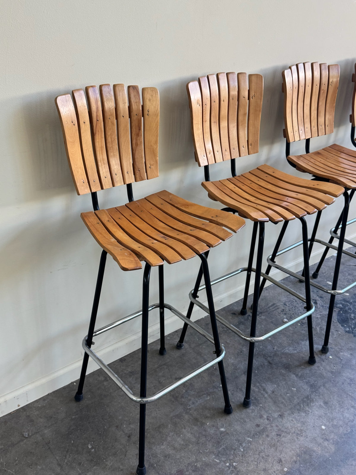 Slatted maple swivel bar stools. Sold in pairs.