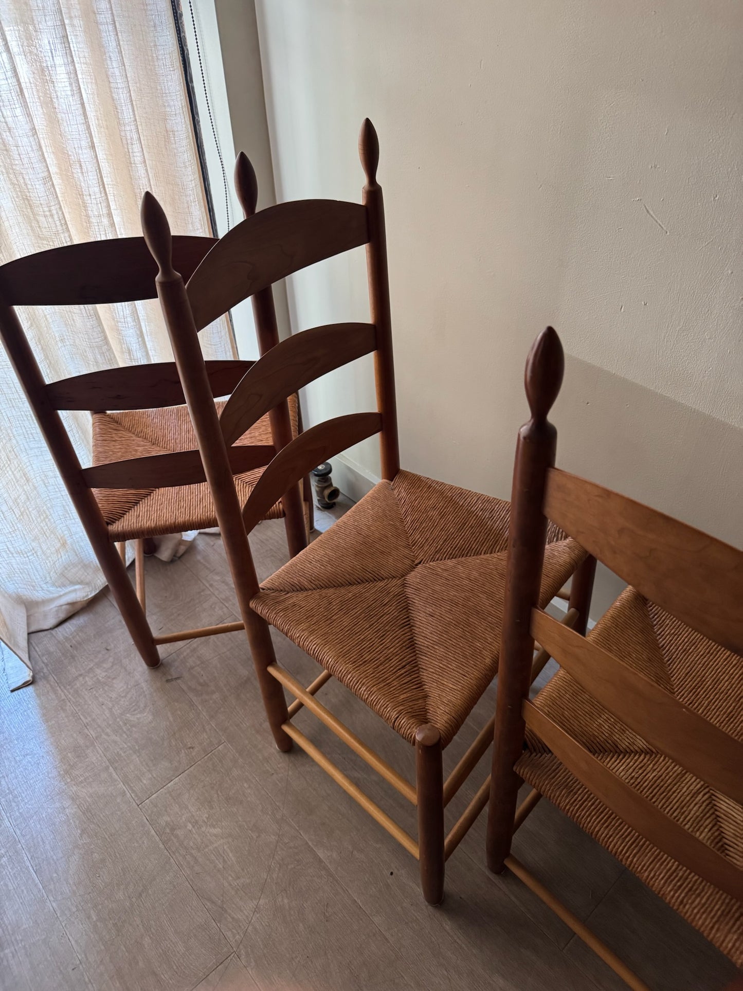 Cherry ladder back rush seat chairs. Sold individually.